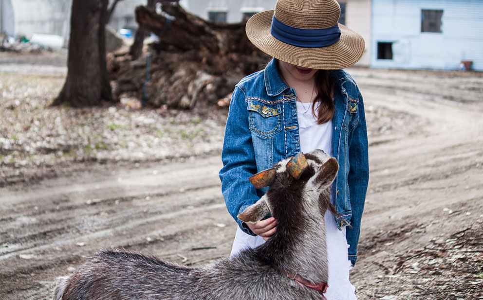 girl petting goat