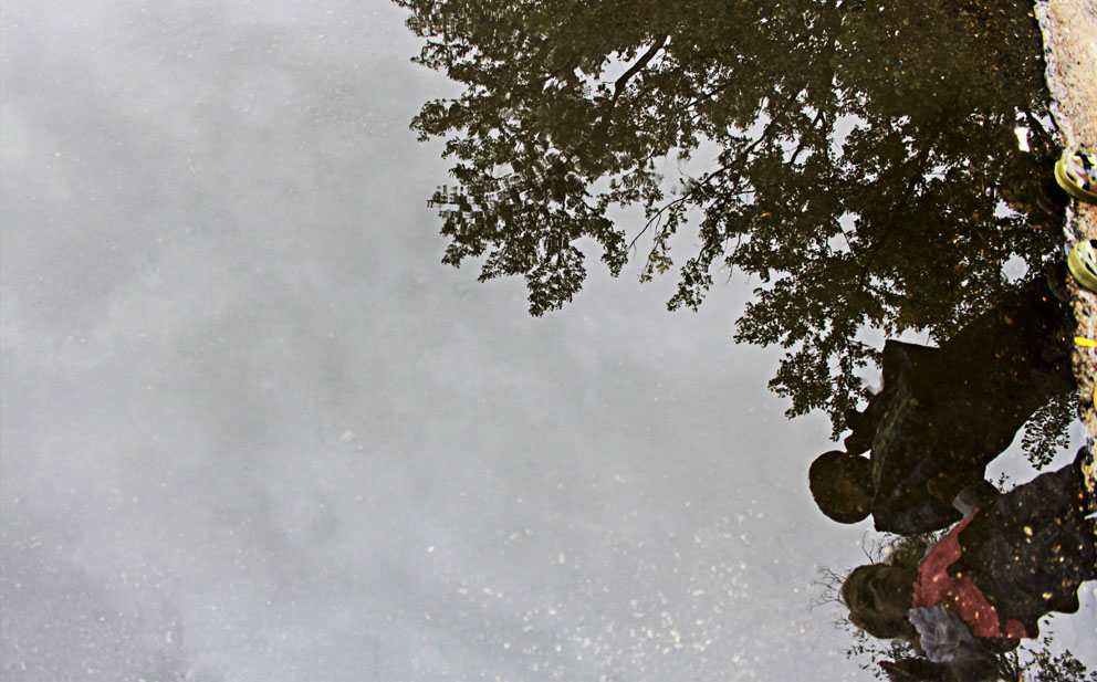 reflection of children in puddle