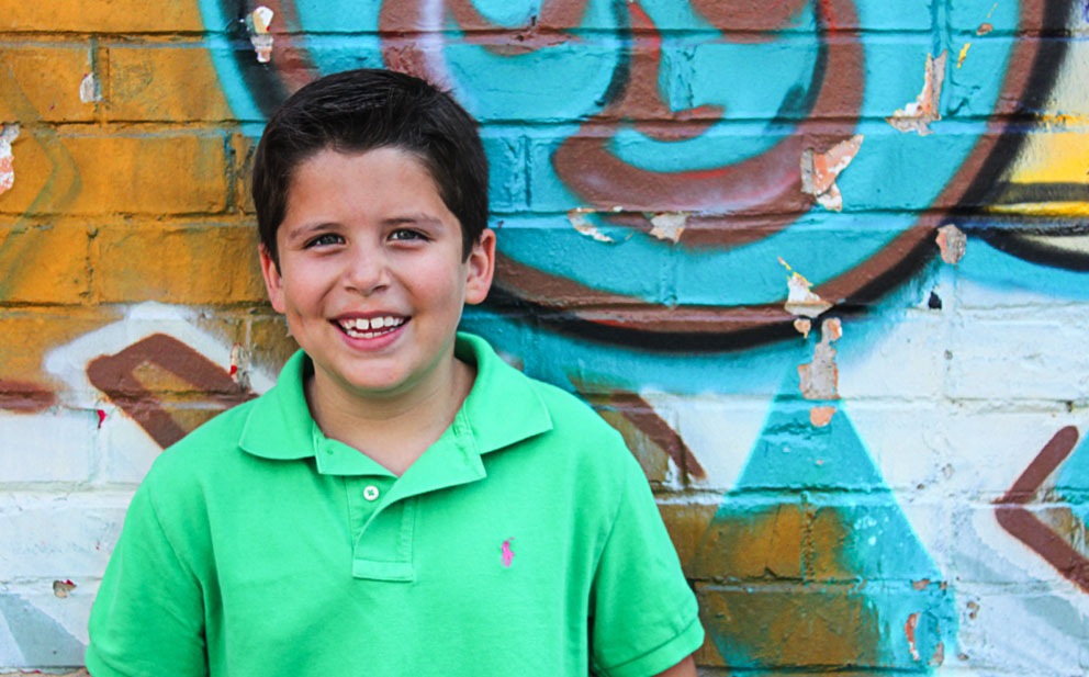 boy against graffiti wall