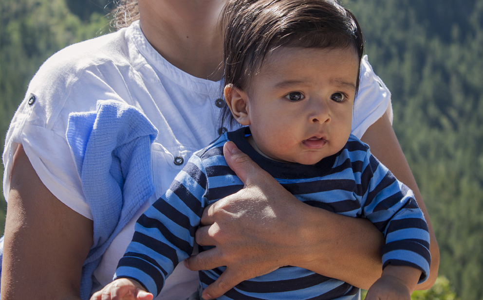 baby boy in mother's arms